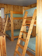 Cabin #15's bunk bedroom with dresser and closet