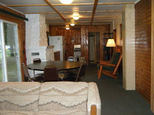 Cabin 1 "great room" flows from Living Area to Dining to Kitchen.  The large dining table is located next to the lakeside sliding patio door.  And the living room is full of picture windows.   What a view!