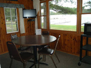 Cabin 2 Dining Area  Picture window faces the lake. Great View!  HDTV TV with cable & DVD player