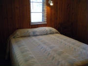 Queen lakeside Bedroom.  Cabin 3 also offers 1 king bedroom and 1 bedroom with 2 twin size beds.  Linens and blankets provided.