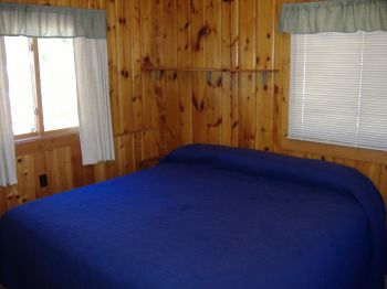 King Bedroom in Cabin #7.  Built in dresser & closet to the right of the bed.  