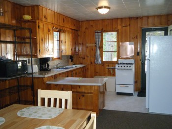 Cabin 6 Kitchen stocked with pots, pans, dishes, coffee pot, microwave, and full size appliances