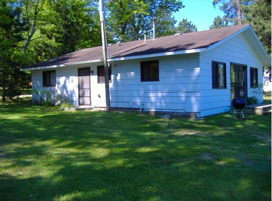 Outside of Cabin #14.  The small door on the side leads out toward cabin #4 or Condo #12.  The main patio door leads directly out to the lake, Picnic Table and BBQ grill. .  This Patio Door is ramped on the side; steps in the front.   