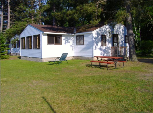 Cabin #4 outside with BBQ grill and picnic table